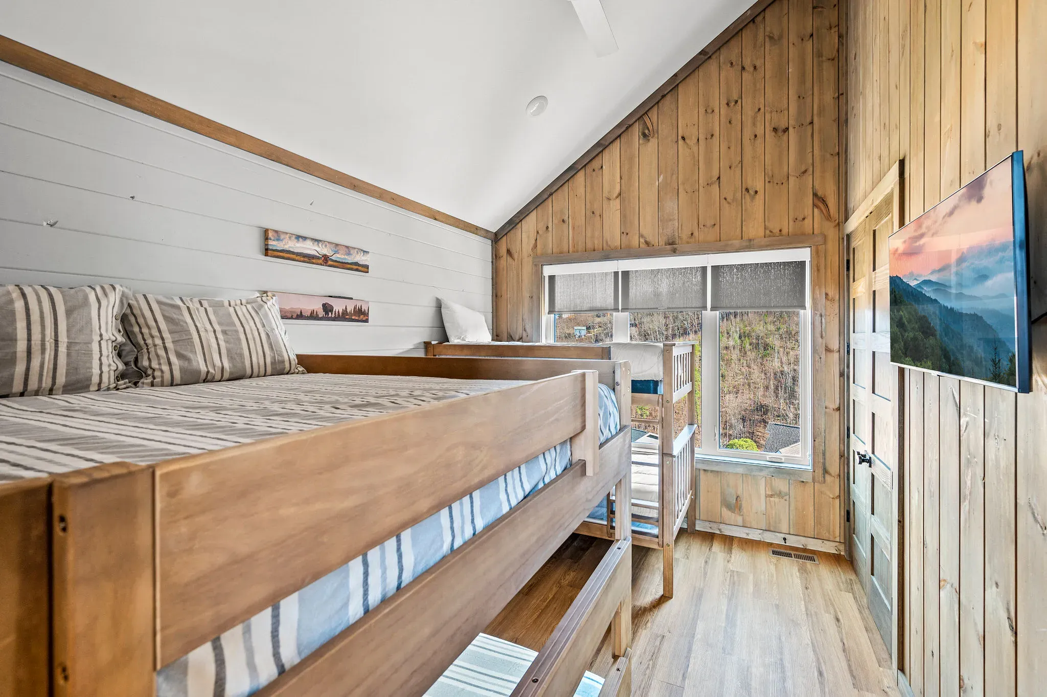 King bedroom with warm timber and soft linens