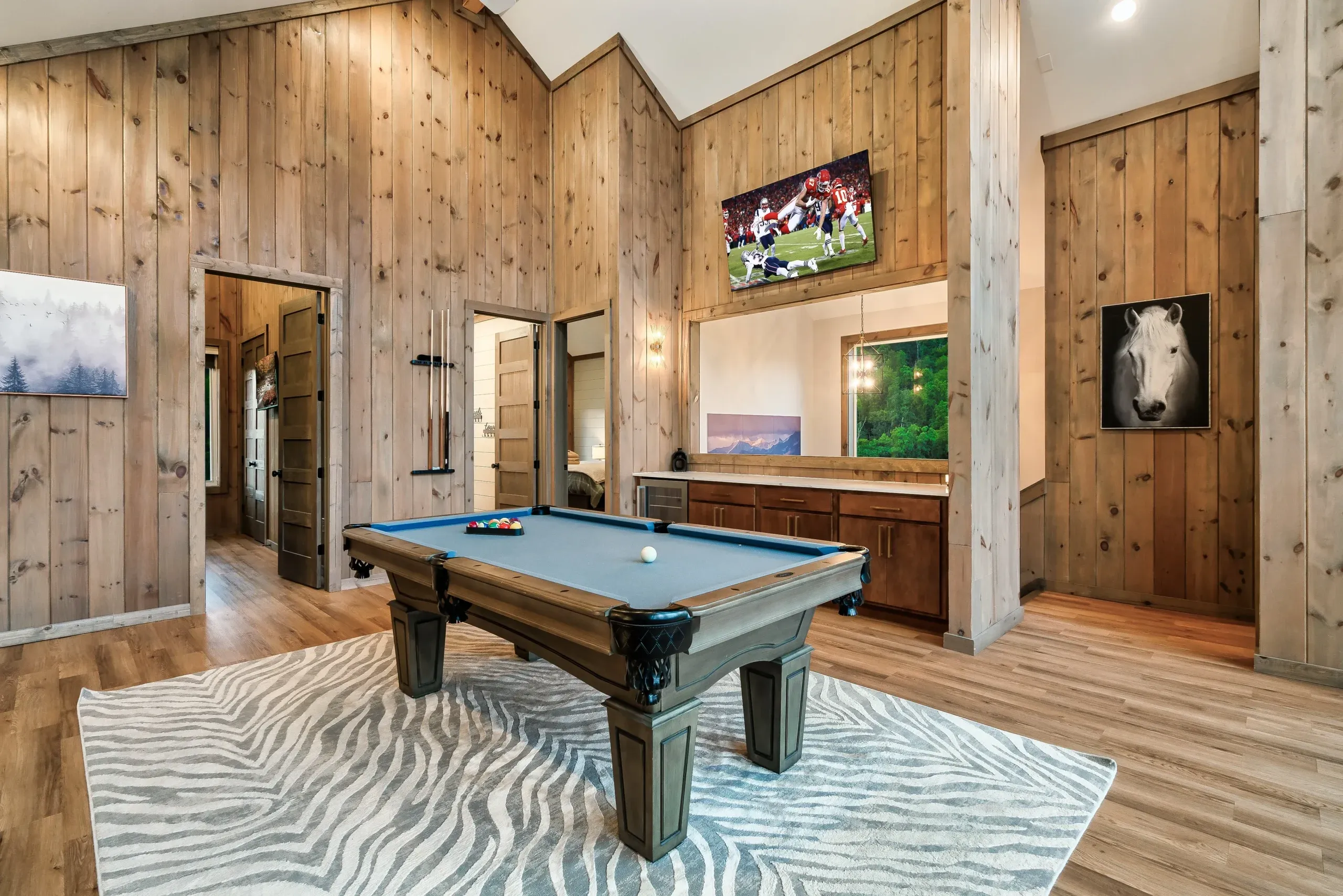 Game room with pool table and bar